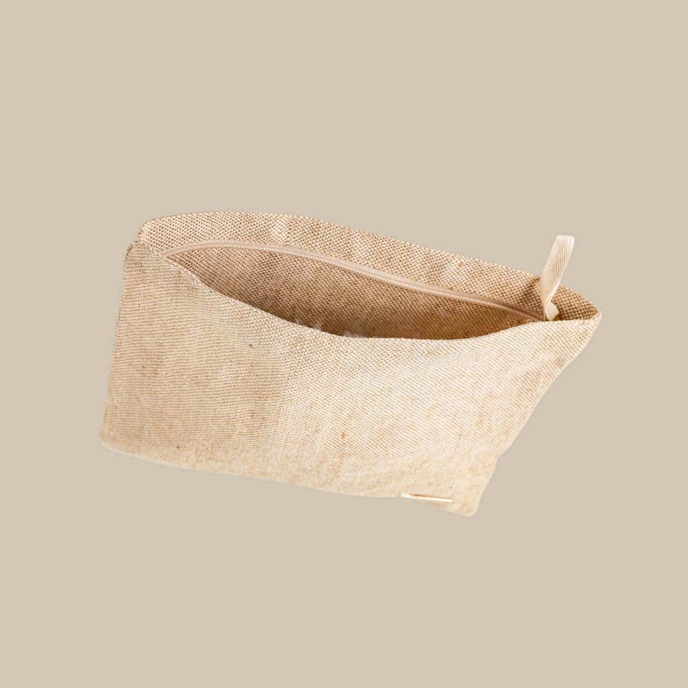 Eco-friendly beige travel tech pouch made from Juco, designed to organize electronics or serve as a stationery/pencil case.