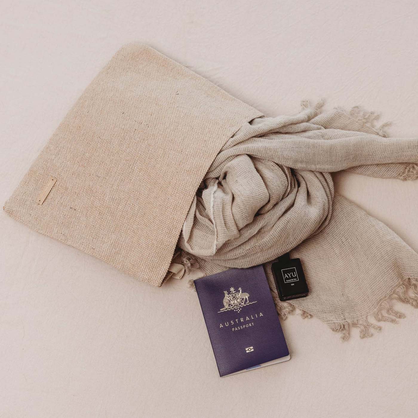 Passport in an Eco-friendly beige travel tech pouch made from Juco, designed to organise electronics or serve as a stationery/pencil case.