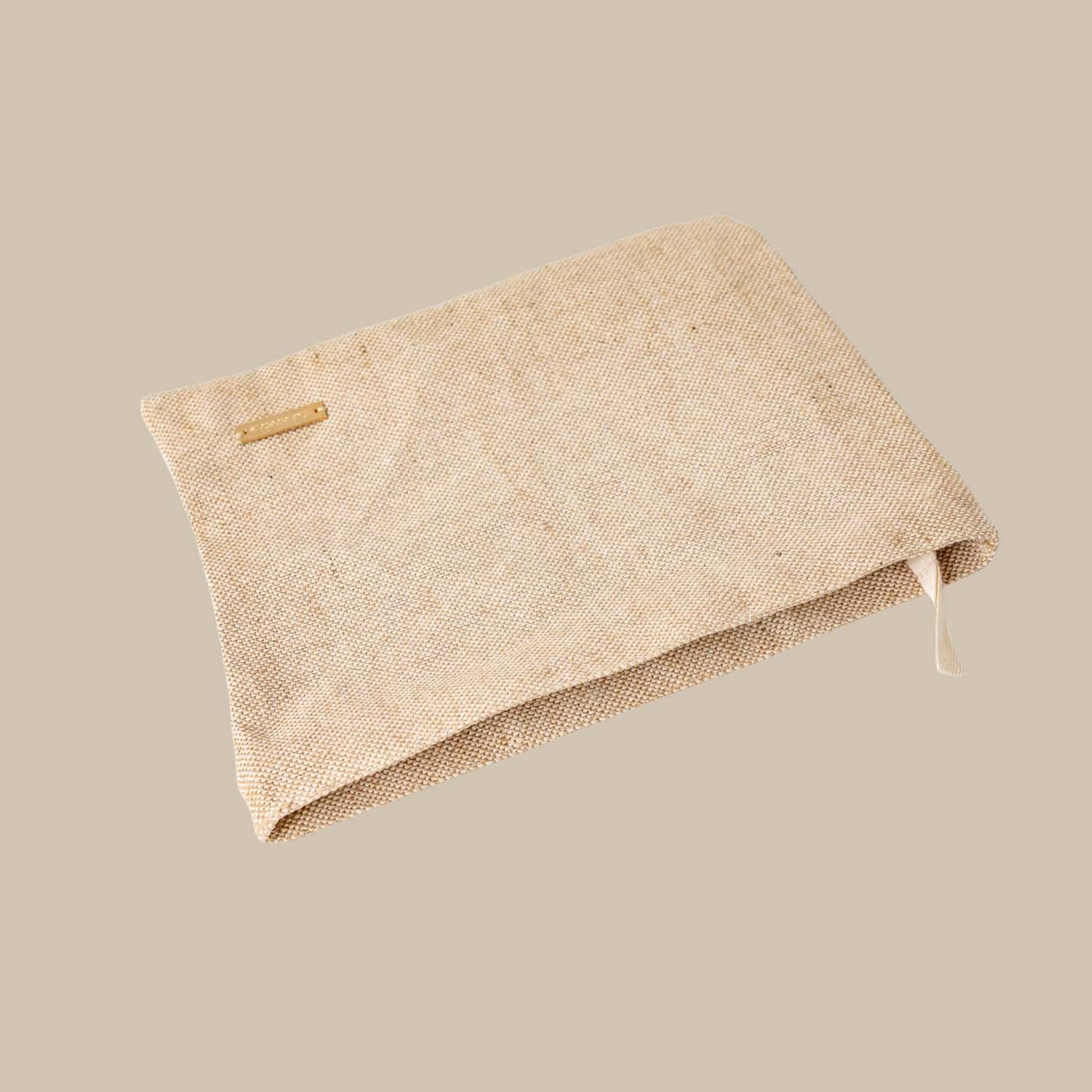 Eco-friendly beige travel tech pouch made from Juco, designed to organize electronics or serve as a stationery/pencil case.