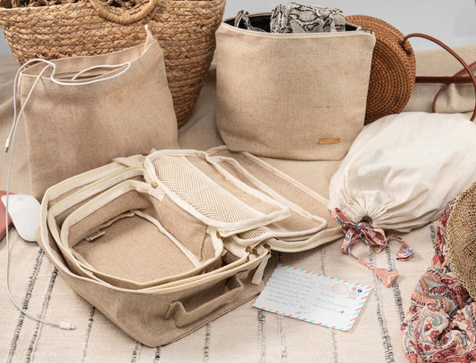 Set of 6 travel packing cubes in beige jute and cotton, including cubes, wet bag, tech bag, and shoe/laundry bag.