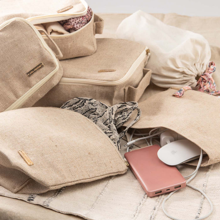 Set of 6 travel packing cubes in beige jute and cotton, including cubes, wet bag, tech bag, and shoe/laundry bag.